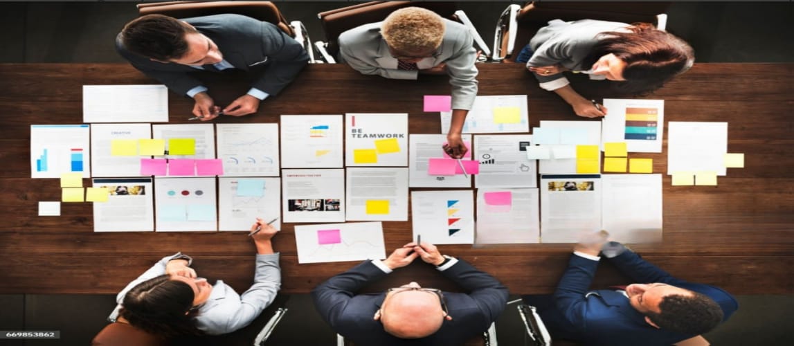 Group of people sitting at a table involved in IT Project Planning