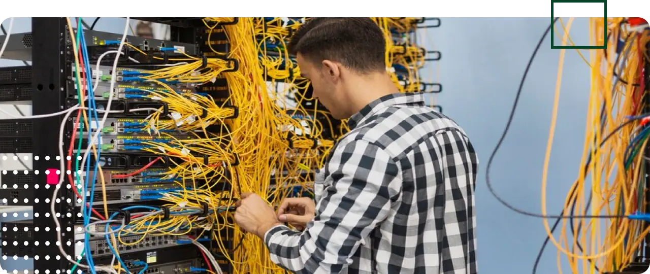 Technician troubleshooting data cables in a data rack